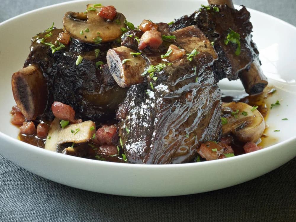 Beef short ribs served on a white plate